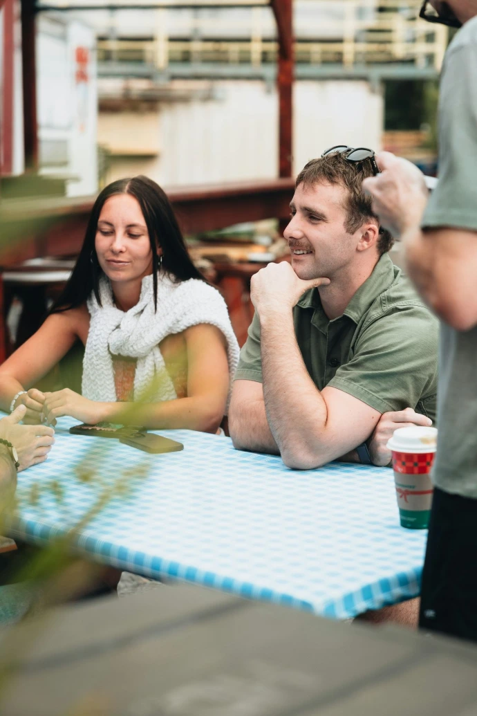 People sitting at a checkered picnic table